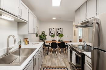 A modern kitchen with a dining table set for four.